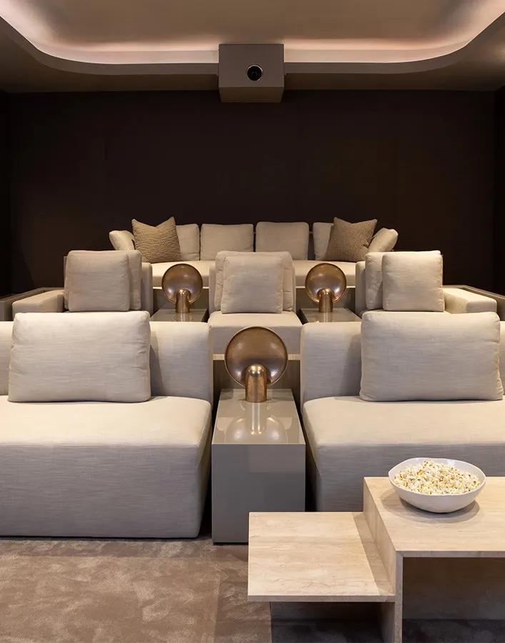 Contemporary cinema room with low platform seating and acoustic walls